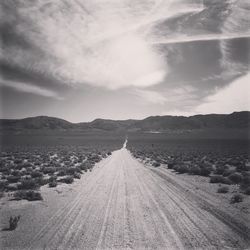 Road amidst landscape against sky