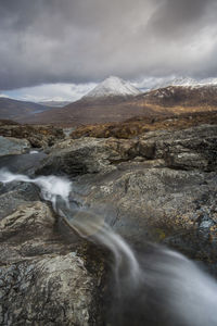 Scenic view of mountains against cloudy sky