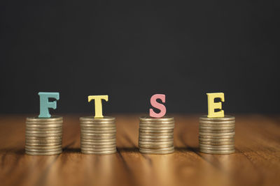 Stack of objects on table against black background
