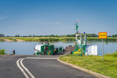 Road by river against sky