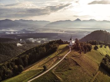 Church on landscape against sky