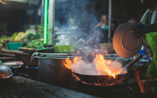 Burning candles on barbecue grill