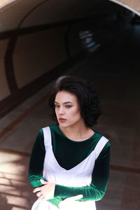 High angle view of beautiful young woman standing on steps