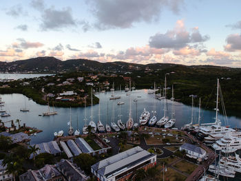 High angle view of boats moored at harbor during sunset