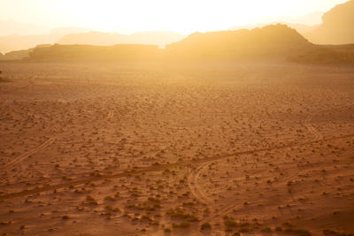 Scenic view of desert against sky during sunset