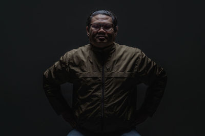 Portrait of man against black background