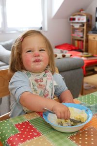 Portrait of cute girl sitting on table