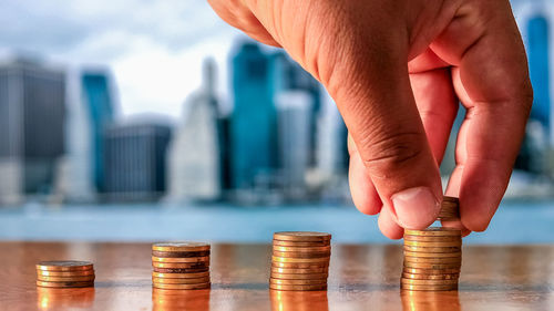 Close-up of hand holding coins