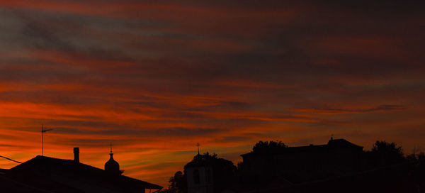 Low angle view of silhouette buildings against sky during sunset