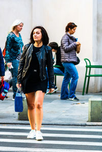 Full length of woman walking on road