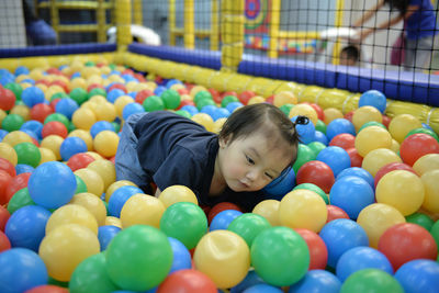 Boy playing with multi colored balloons