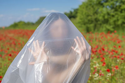 Low section of woman holding umbrella