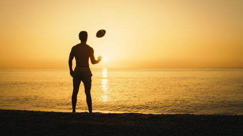 Silhouette of a football player with ball