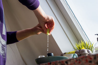 Midsection of woman preparing food in kitchen