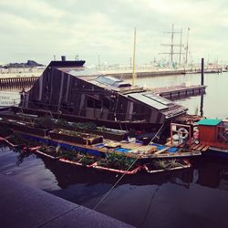 View of harbor against cloudy sky