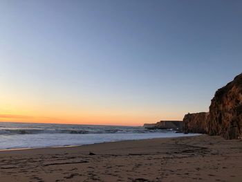 Scenic view of sea against clear sky during sunset