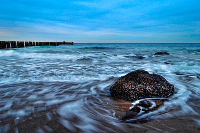 Scenic view of sea shore against sky