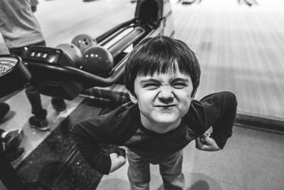 High angle view portrait of boy making face