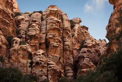 Low angle view of rock formations against sky