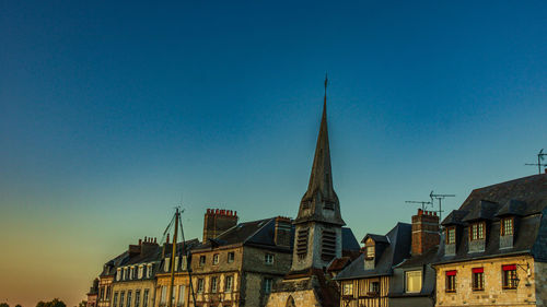Low angle view of buildings against clear blue sky