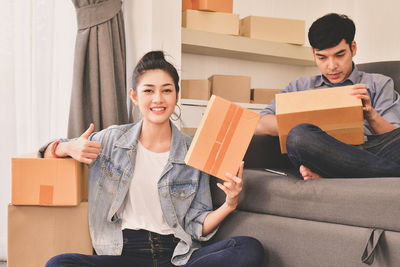 Portrait of woman with colleague working in office