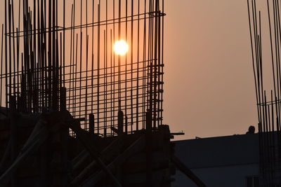 Low angle view of silhouette building against sky during sunset