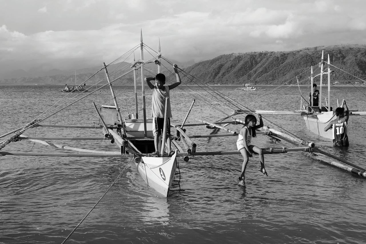 real people, sky, water, nautical vessel, fishing net, nature, men, sea, transportation, outdoors, leisure activity, lifestyles, cloud - sky, day, commercial fishing net, fisherman, occupation, fishing equipment, scenics, outrigger, people