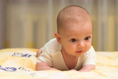 Cute baby boy lying on bed