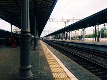 Train at railroad station against sky