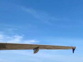 Low angle view of airplane on roof against sky