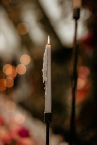 Close-up of lit candles on building