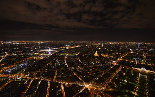 Aerial view of illuminated cityscape against sky at night