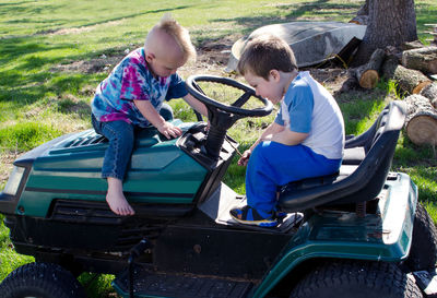 Two little boys talking about a lawn mower. cool stuff