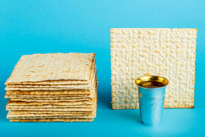 Close-up of drink served on table against blue background