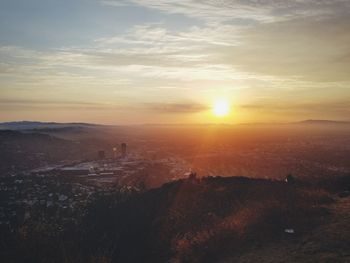 Scenic view of sunset over city