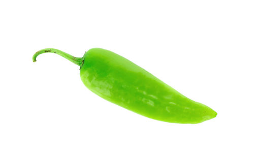 Close-up of green chili pepper against white background