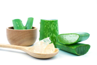 Close-up of green chili pepper against white background