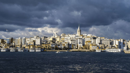 Beautiful dark clouds over galata tower old colorful houses istanbul cityscape bosphorus sea