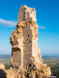 Old ruin building against blue sky