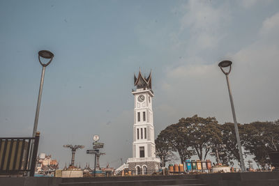 Street light by building against sky