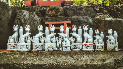 Statues on rock against temple