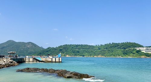 Scenic view of sea against clear blue sky