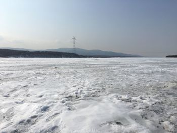 Scenic view of sea against clear sky during winter