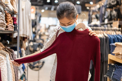 Midsection of woman standing at store