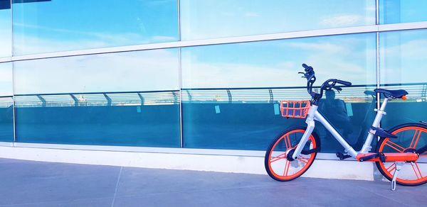 Bicycle by railing against sky