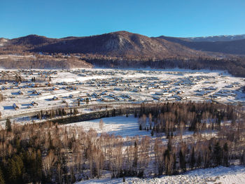 Scenic view of snowcapped mountains against clear blue sky