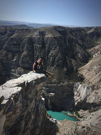 Man standing on rock by mountain