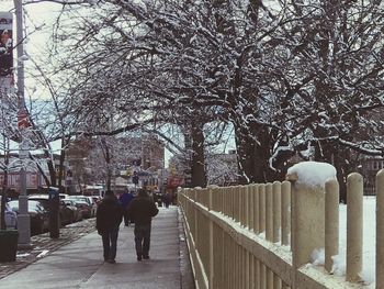 Full length of man on snow covered railing