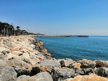 Scenic view of sea against clear blue sky