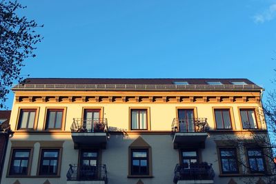 Low angle view of residential building against blue sky